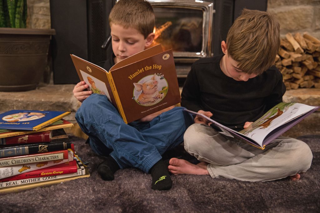 Two boys absorbed in reading